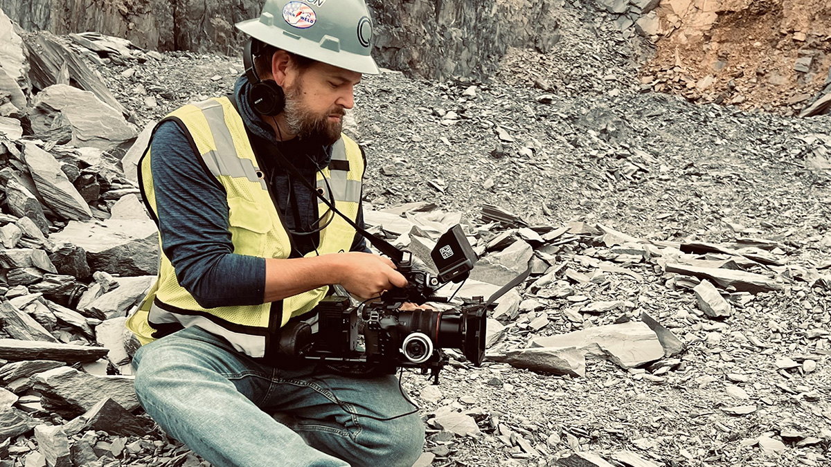 a man in a rock quarry filming