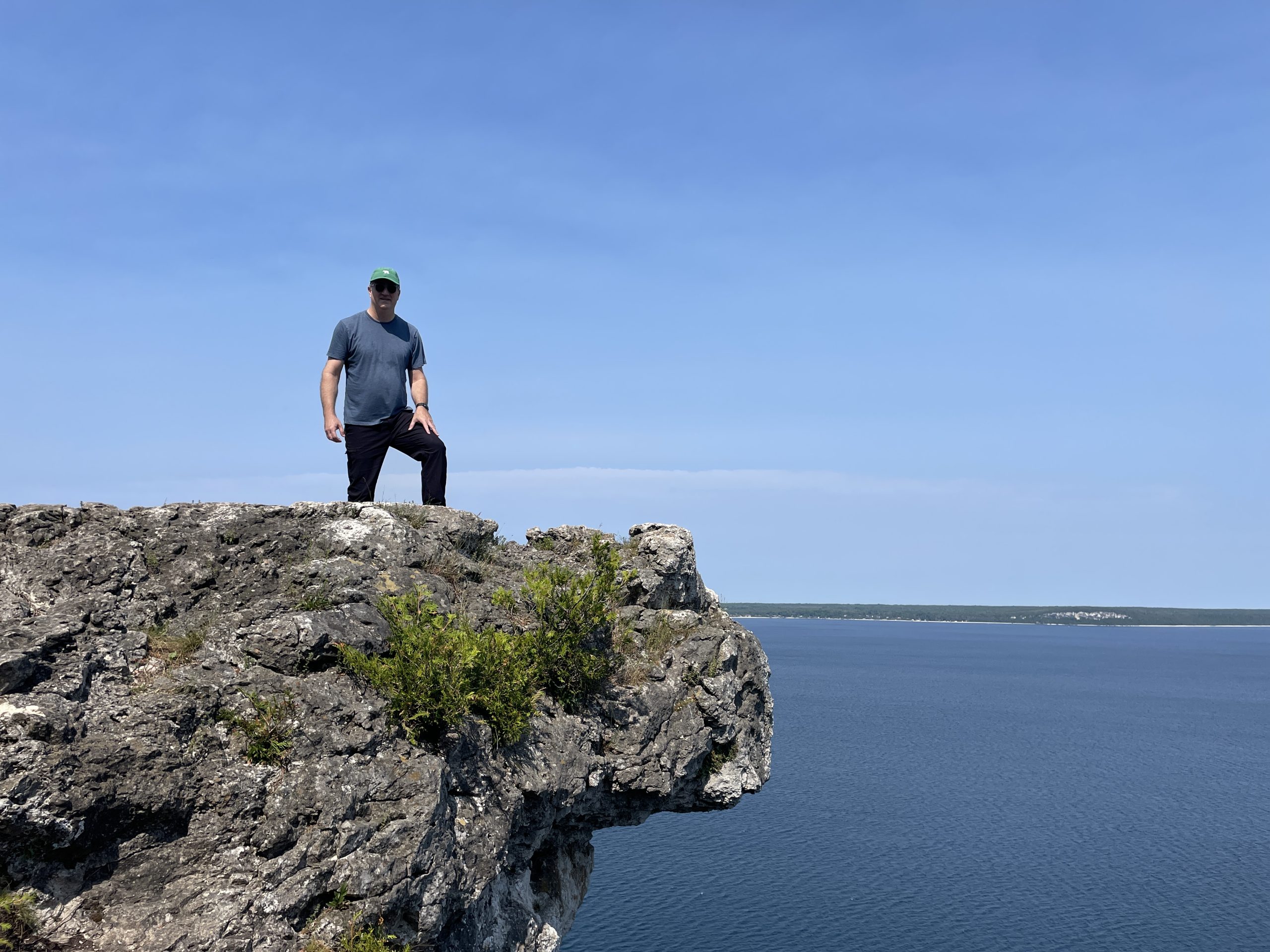 a man standing on a rock above water